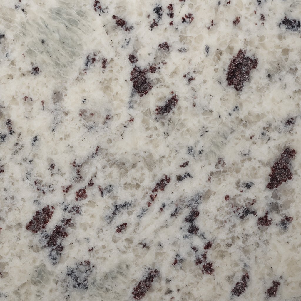 Granito blanco con motas negras y grises, ideal para cocinas y baños.